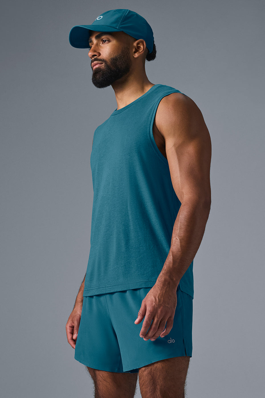 Model wearing activewear dress with Oceanic Teal Triumph Muscle Tank.