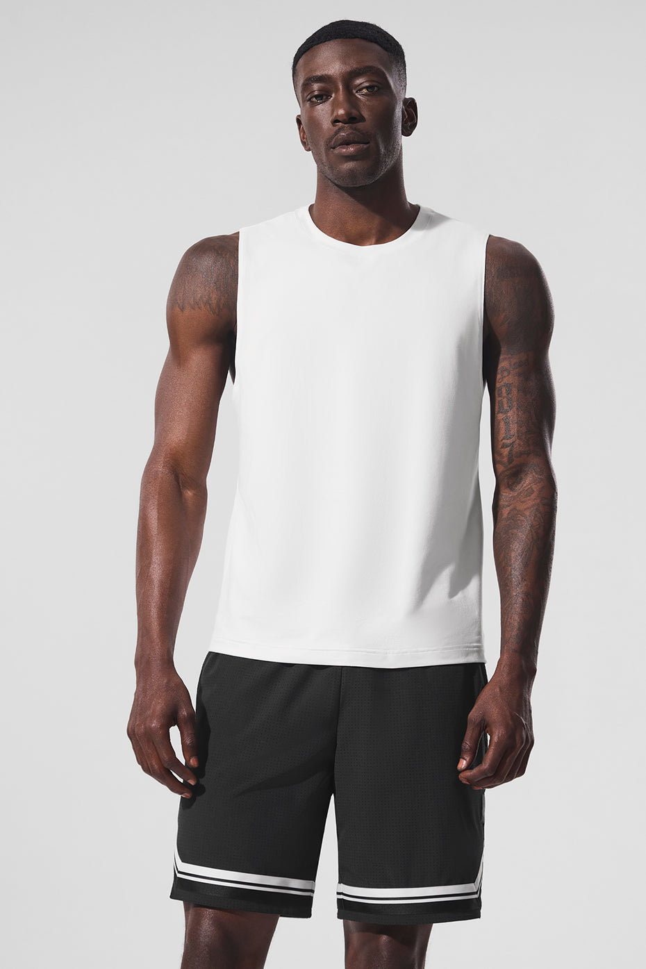 Front view of Conquer Performance Muscle Tank in white, showcasing its breathable fabric.