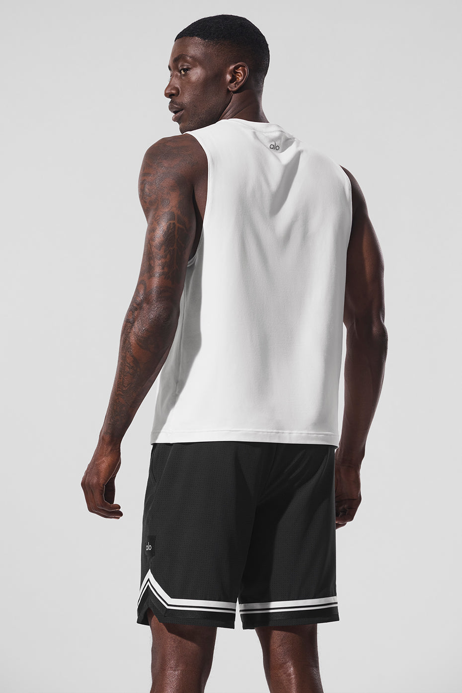 Side view of the Conquer Muscle Tank, highlighting the wide armholes and crew neck design.