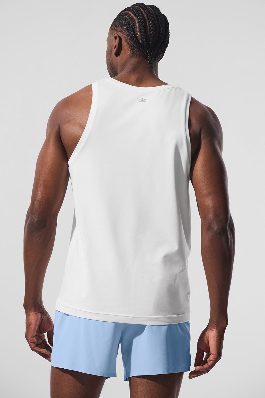 Side view showcasing the relaxed fit of the Conquer tank top during a workout.