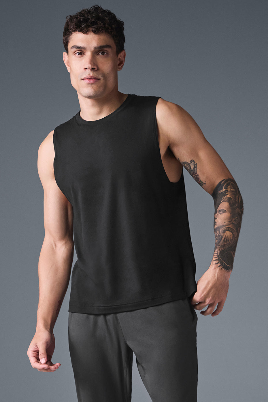 Front view of black workout tank tops for women with wide armholes and crew neckline