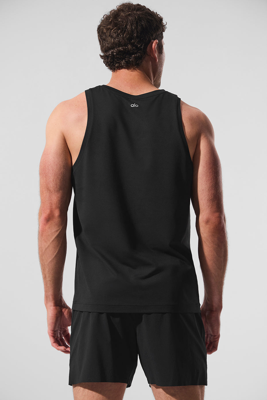 Model wearing the Conquer Tank during a workout, showcasing comfort and style