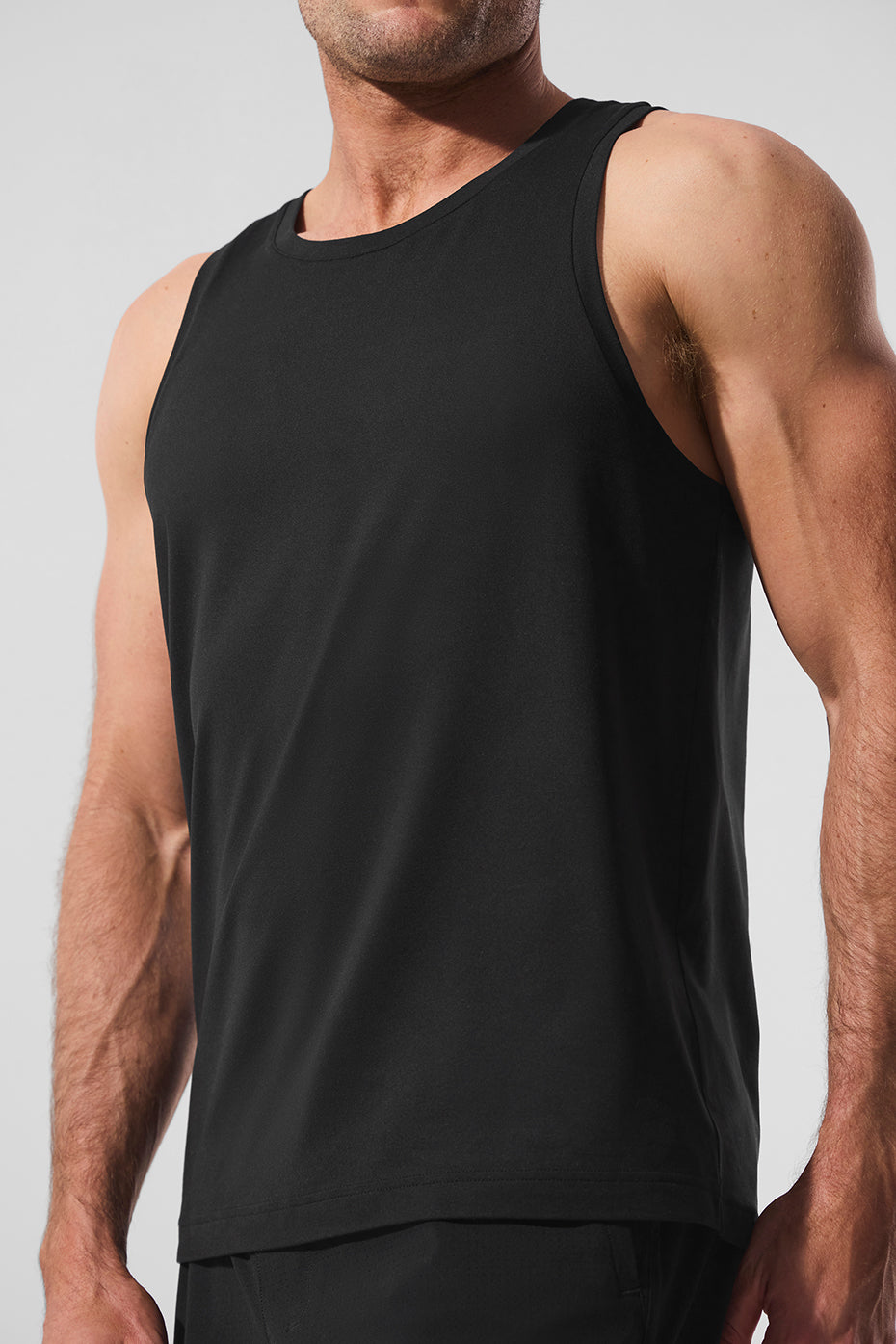 Front view of Conquer Tank in black, highlighting its relaxed fit and breathable fabric
