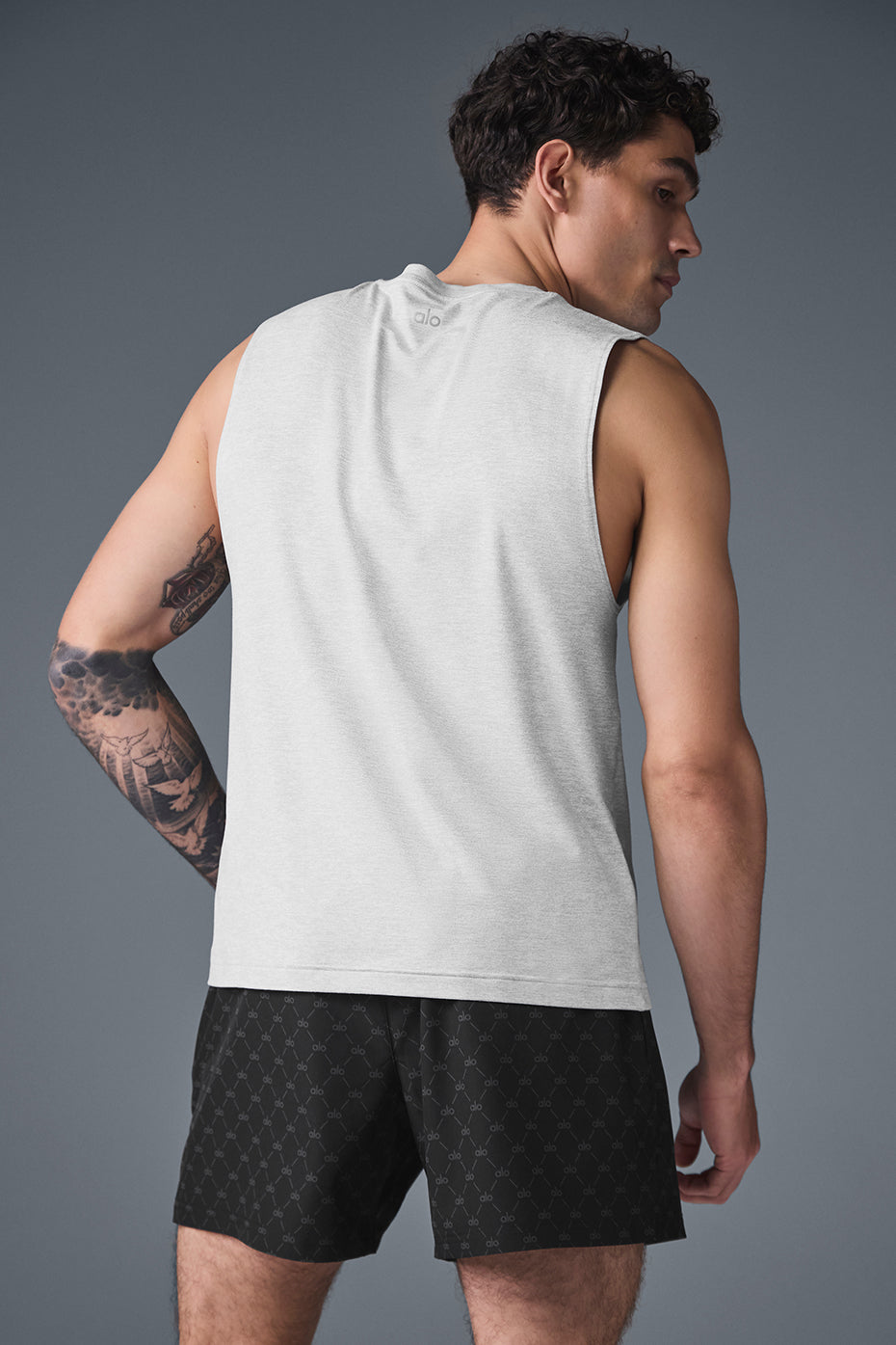 Athlete wearing Conquer muscle tank during crossfit workout in gym