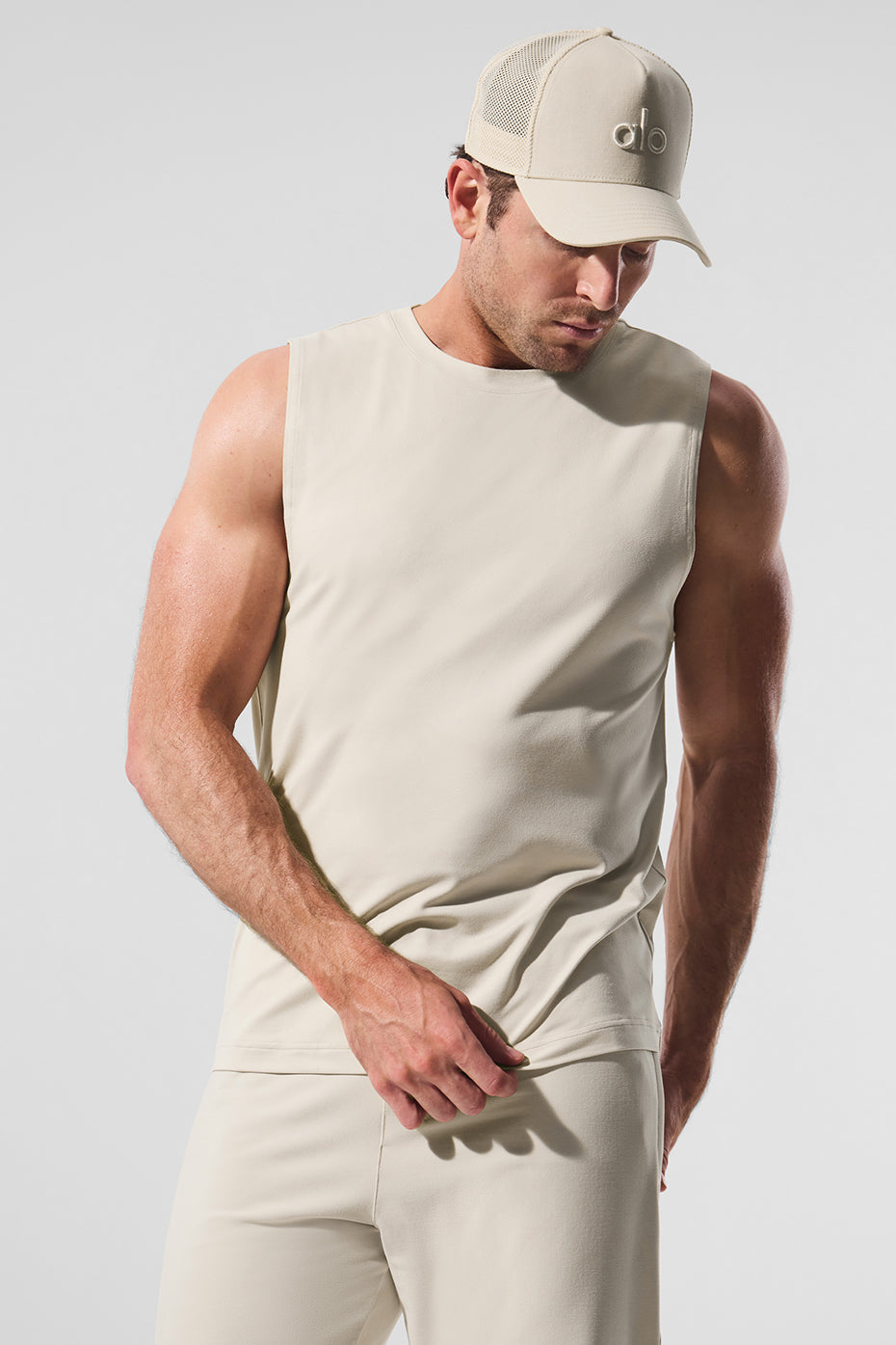 Front view of Conquer Performance Muscle Tank in Bone, ideal for gym sessions.