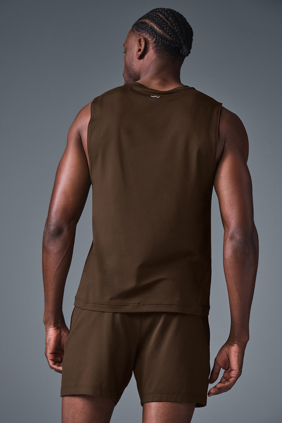 Model wearing the muscle tank during workout in gym setting