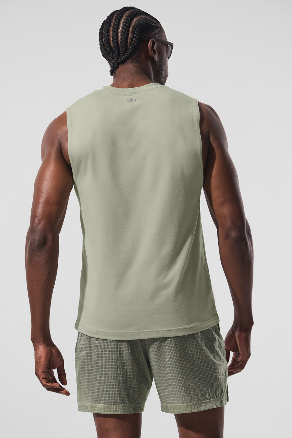 Side angle showing the breathable fabric of the womens muscle tank in limestone.