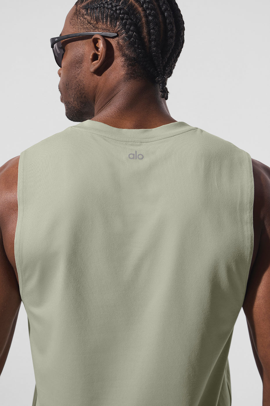 Side angle showing the breathable fabric of the womens muscle tank in limestone.