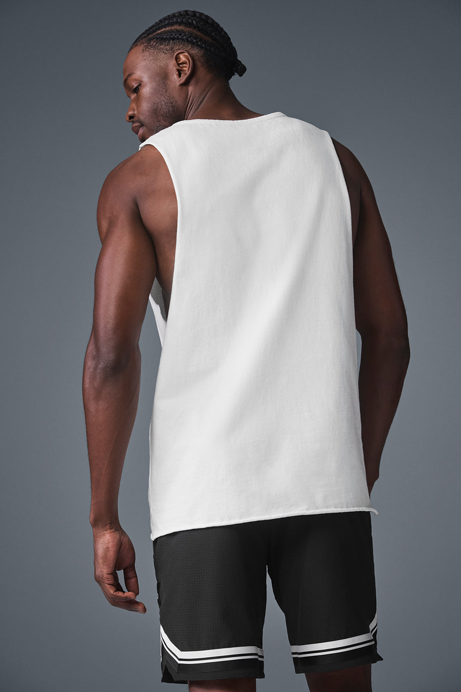 Model wearing a gym tank top with raw edge hem during workout