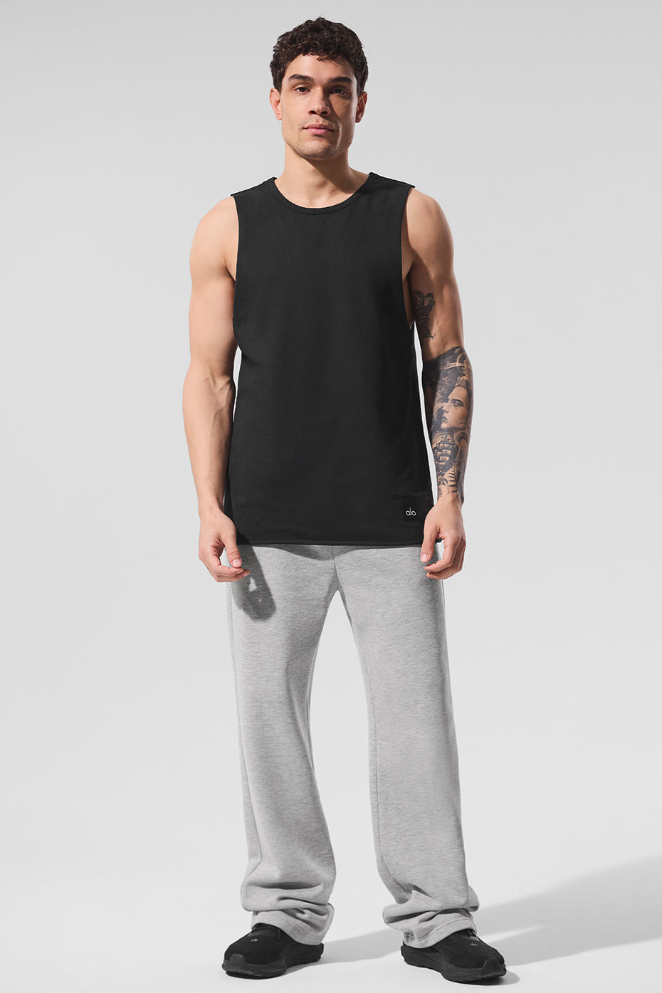 Front view of the black tank top showcasing raw edge design.