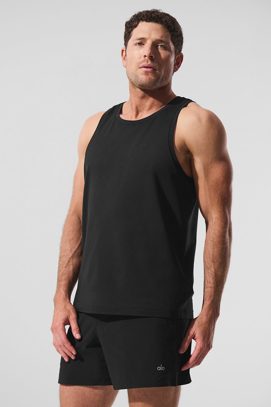 Front view of Conquer Tank in black, highlighting its relaxed fit and breathable fabric