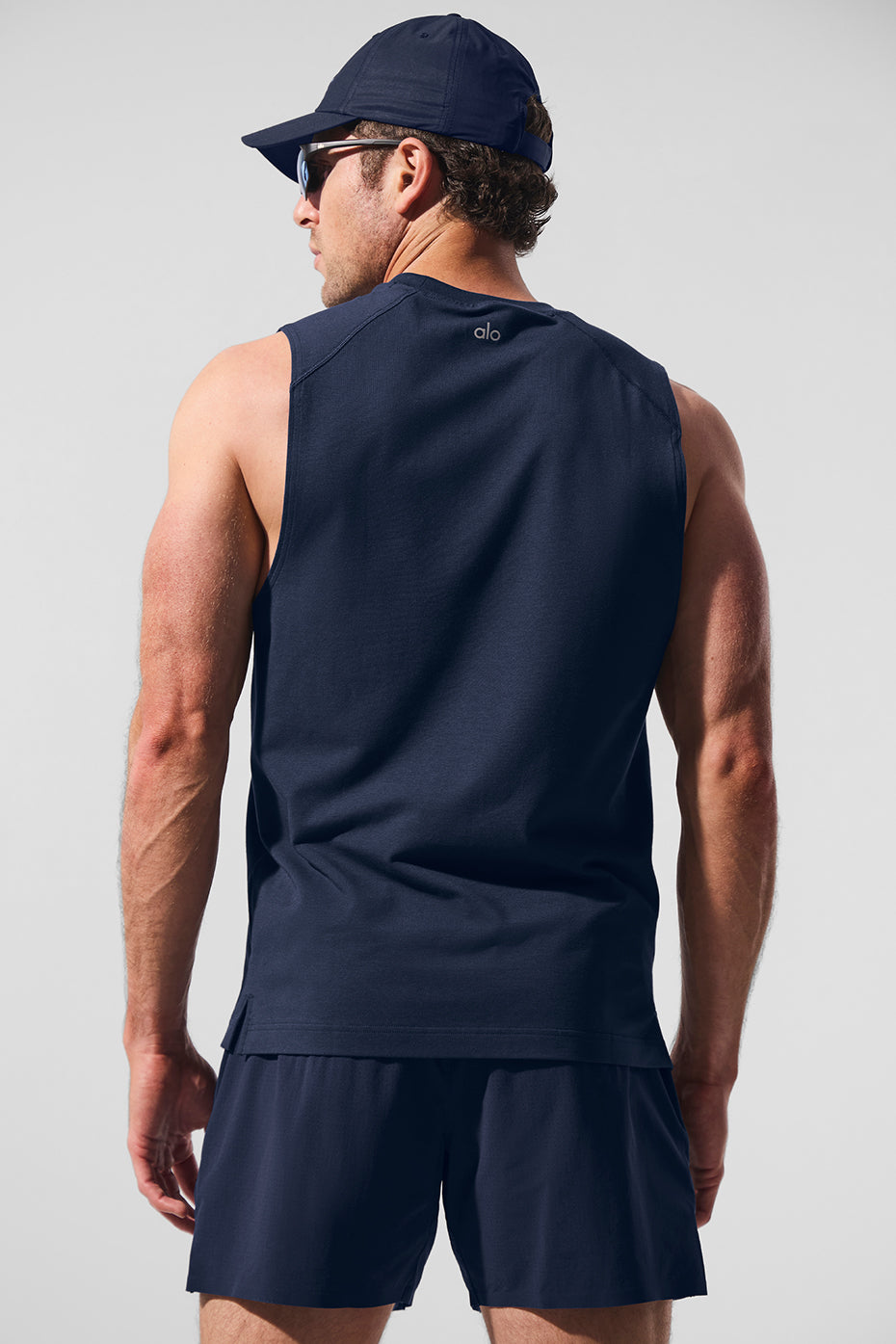 Side view of womens muscle tank top paired with leggings for activewear look
