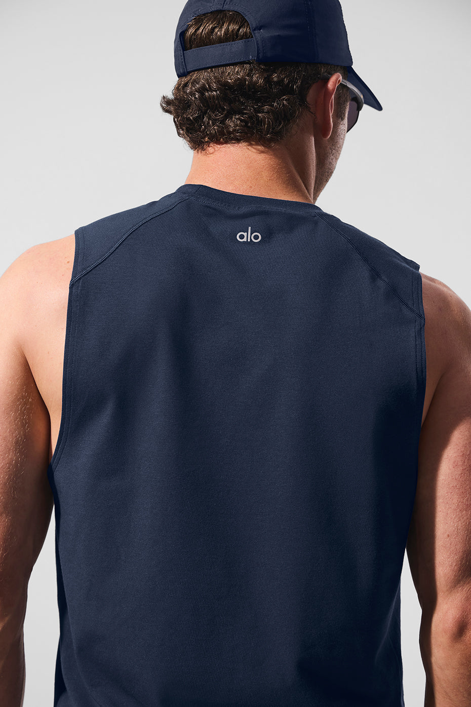 Side view of womens muscle tank top paired with leggings for activewear look