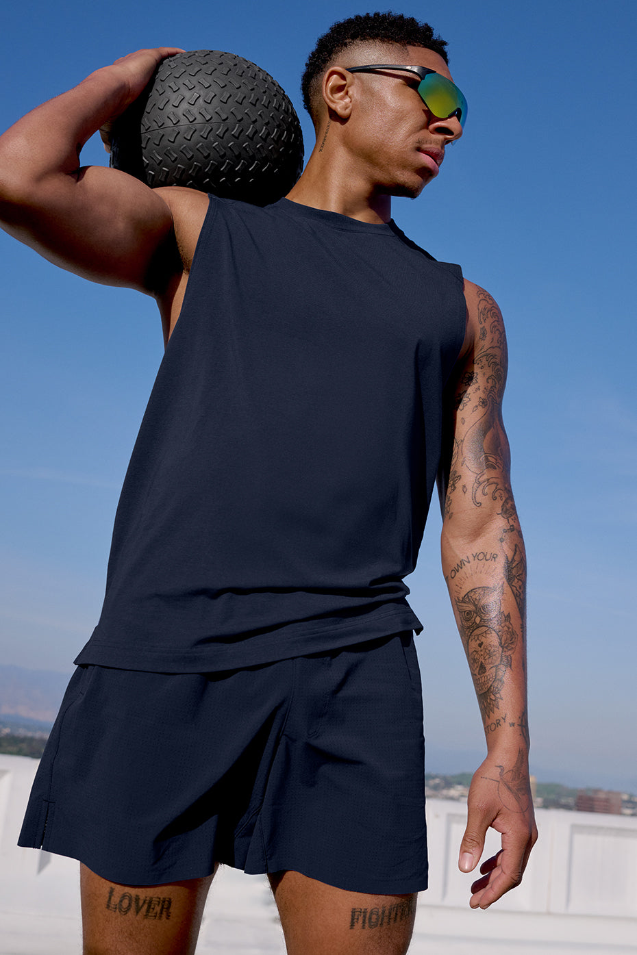 Back view of fitness tank tops worn outdoors for warm-weather training