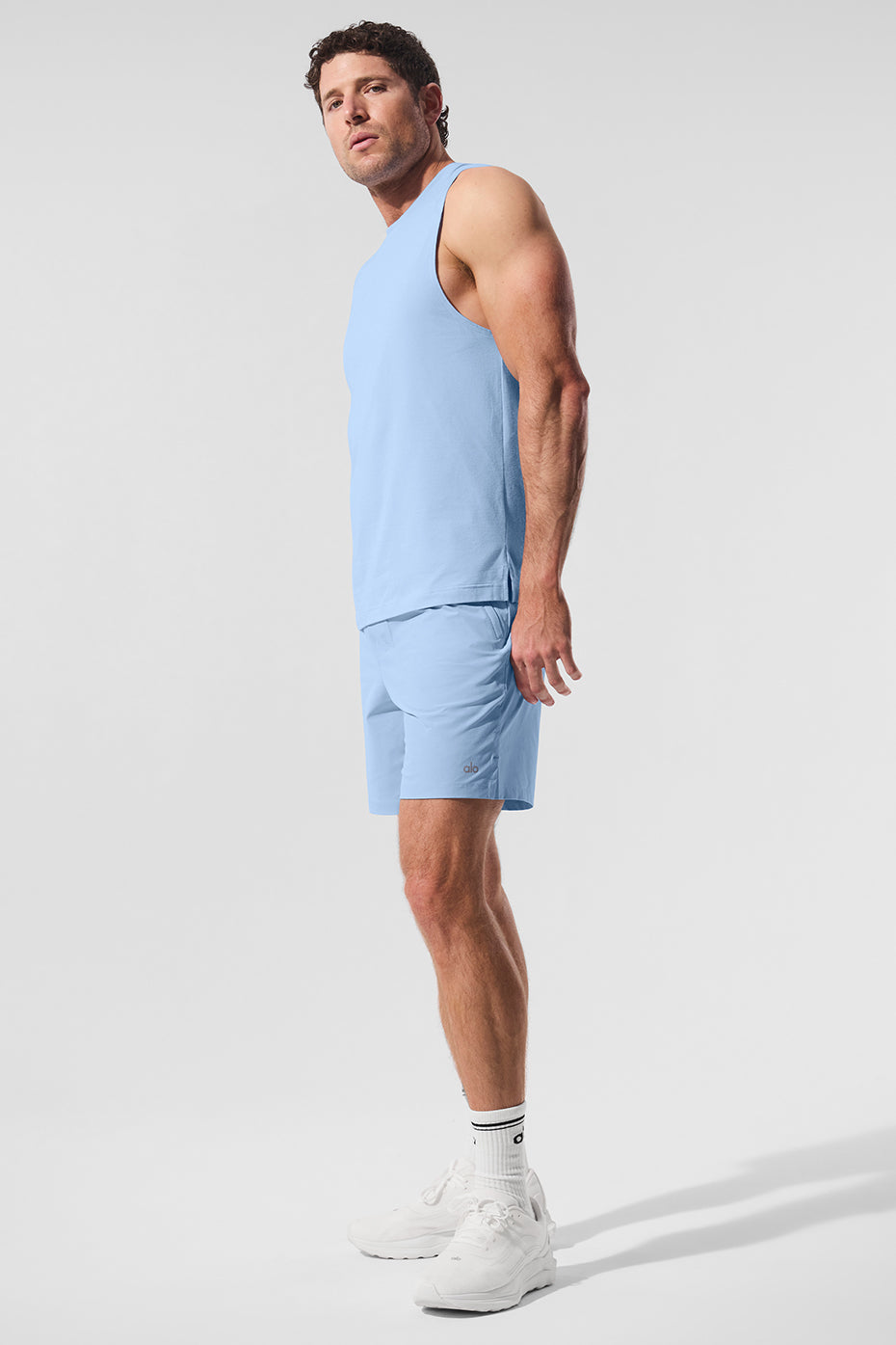 Front view of the Seashell Blue ALO Vapor Muscle Tank in a gym setting