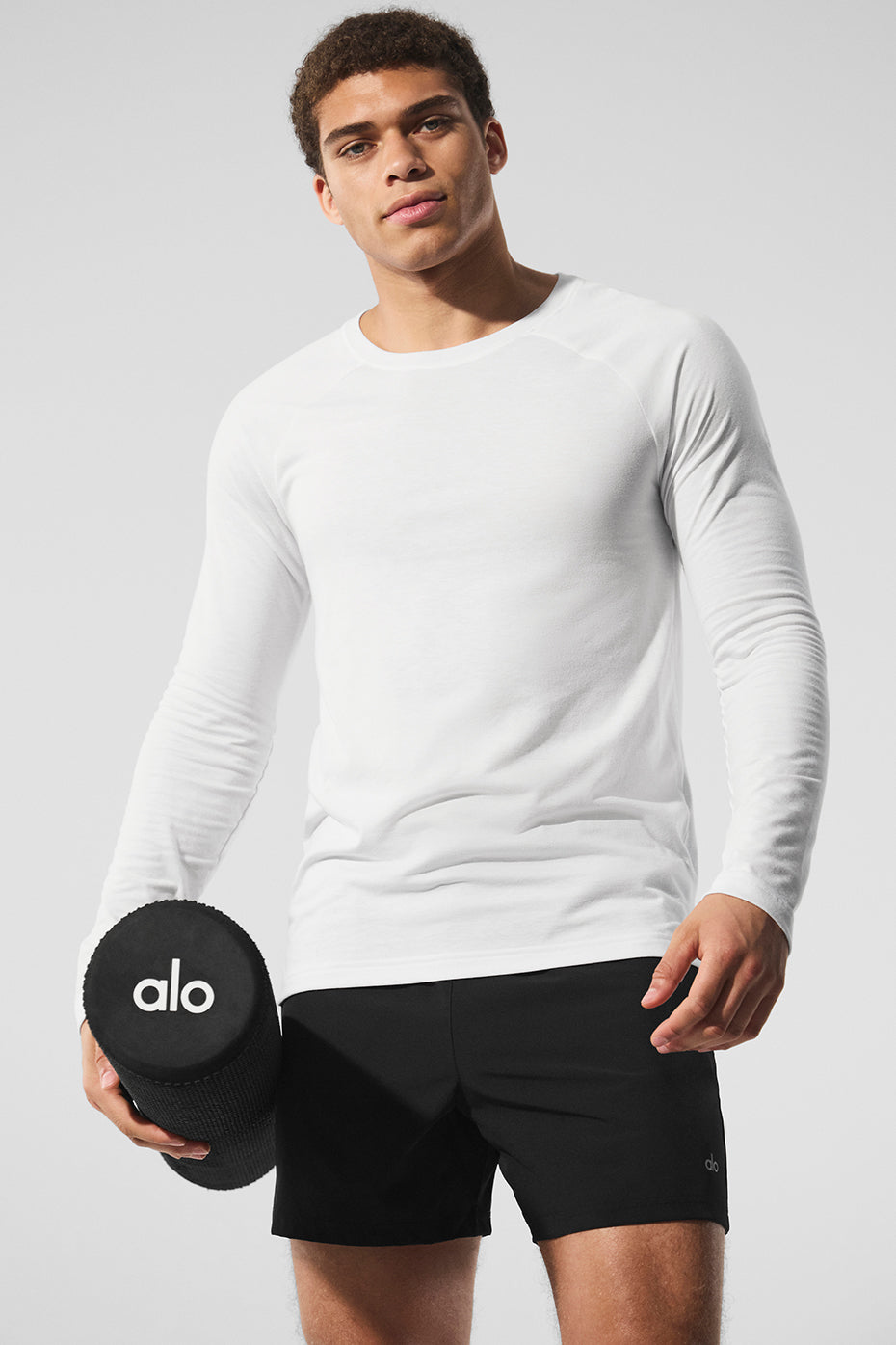 Front view of the white long sleeve t shirt on a model, showcasing slim fit and comfortable style