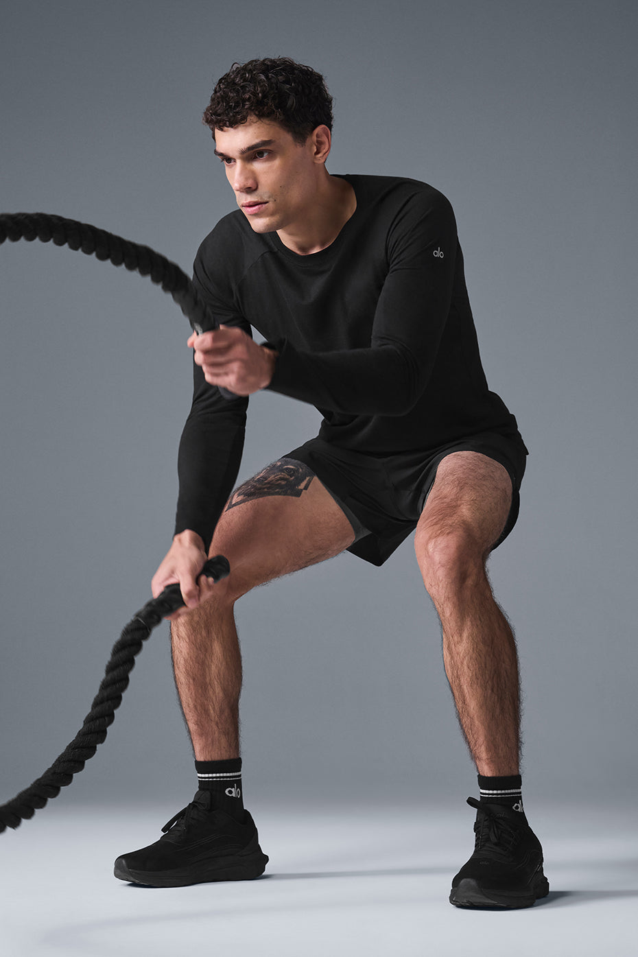 Front view of the black long sleeve tee on a model, casual street style