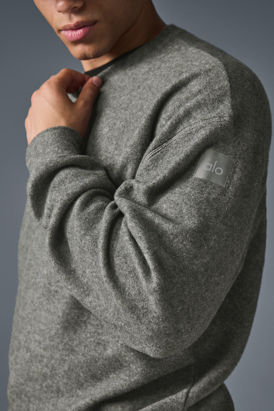 Front view of the grey crew neck sweatshirt highlighting the reverse side panels