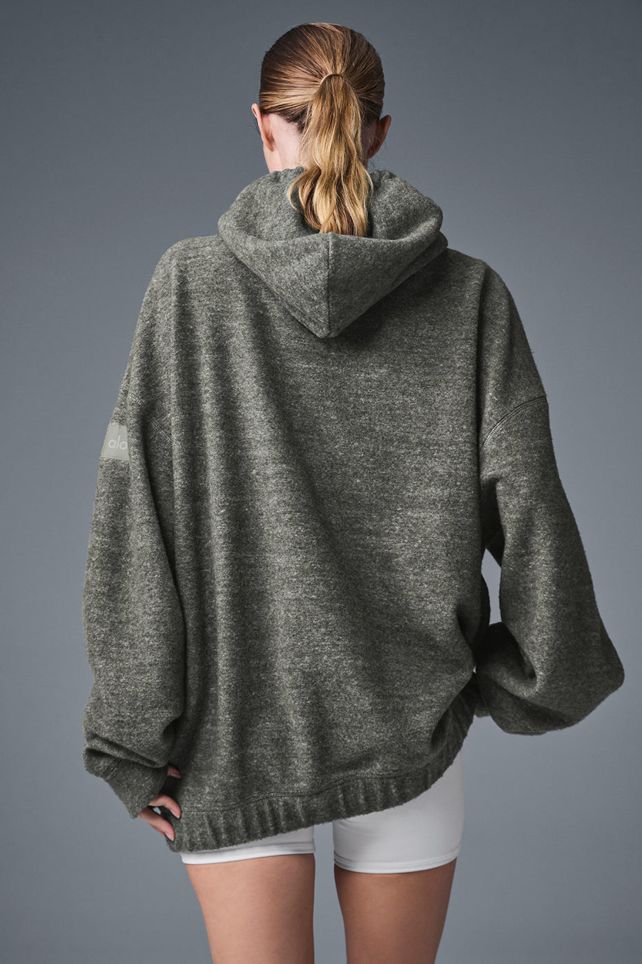 Side view of the Triumph hoodie with hidden zippered pockets, ideal for activewear.