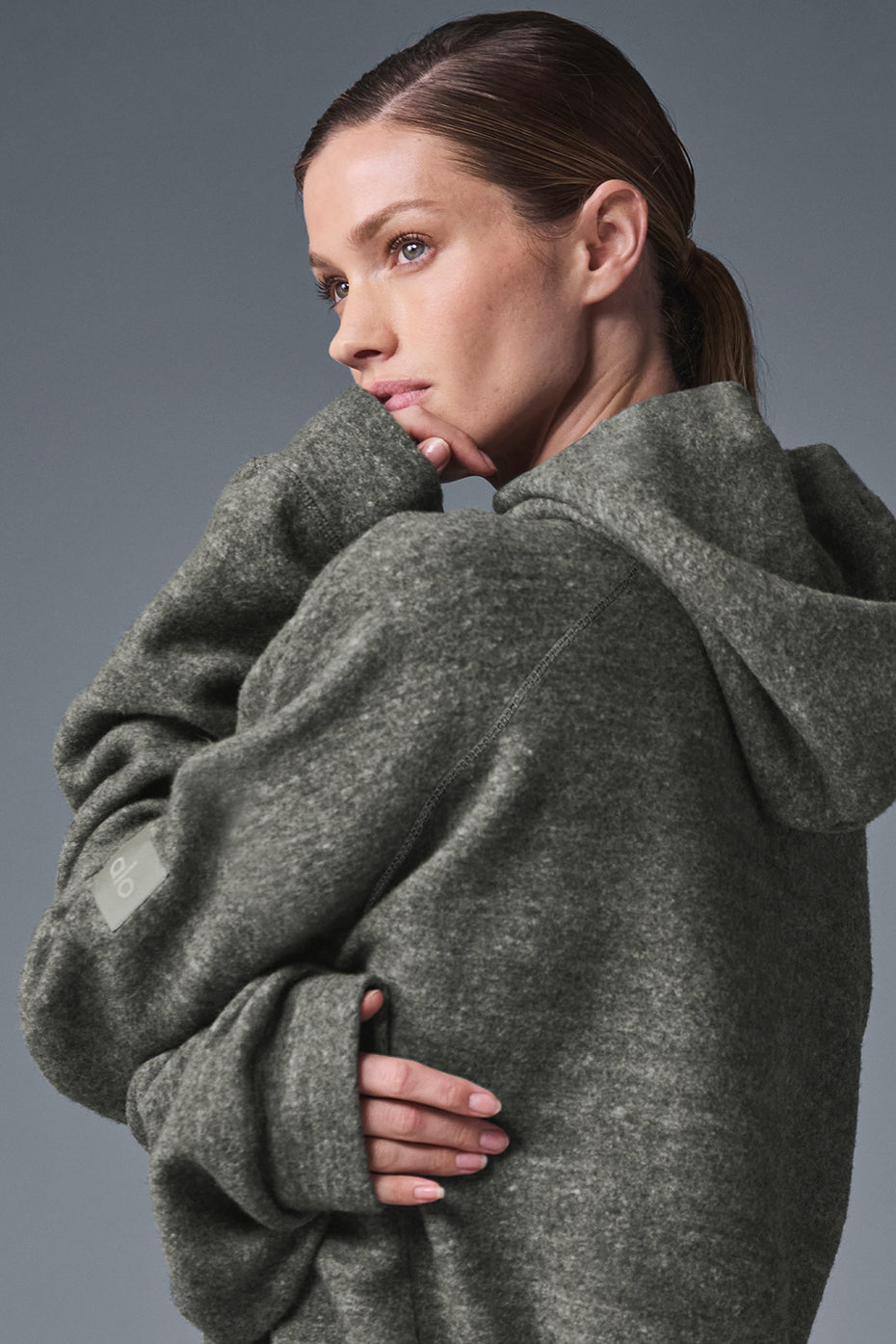 Model wearing the Triumph Comfort Hoodie during a yoga session, highlighting its comfort.