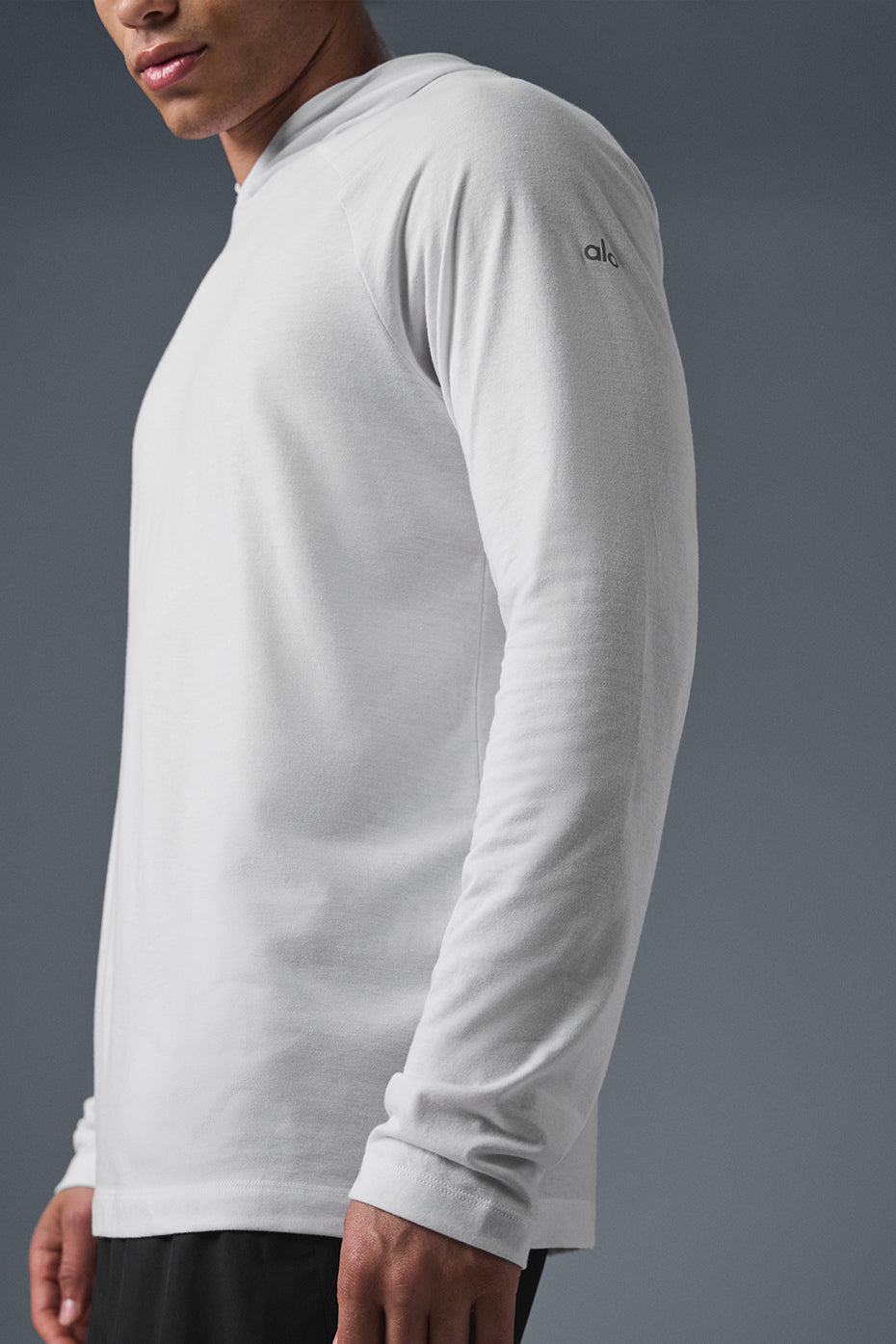 Model wearing the Core Hooded Runner during a workout, highlighting its comfort and versatility