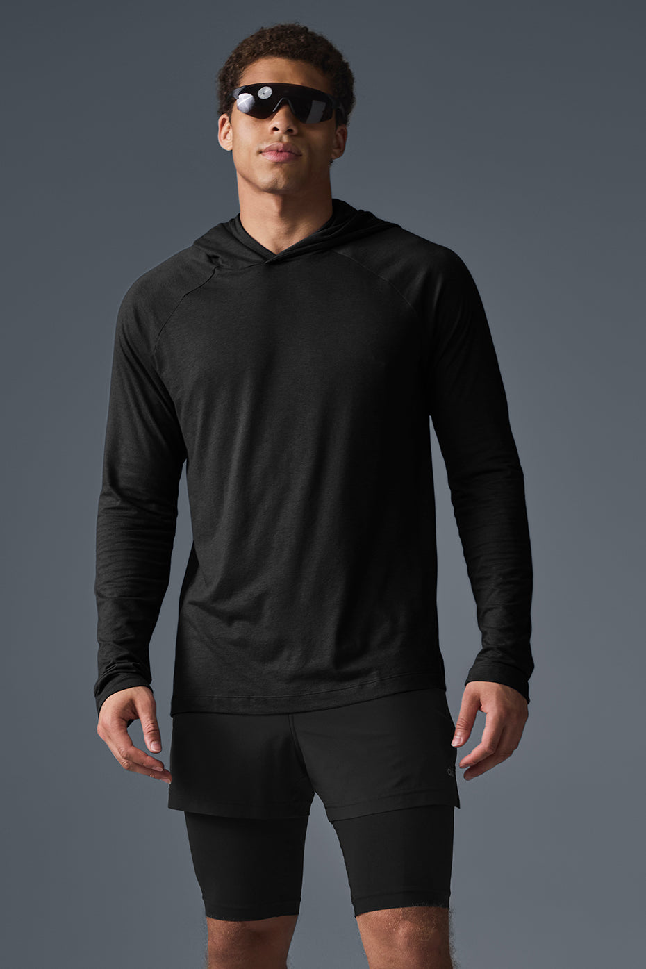 Close-up of the Core Hooded Runner black hoodie highlighting the raglan sleeve design