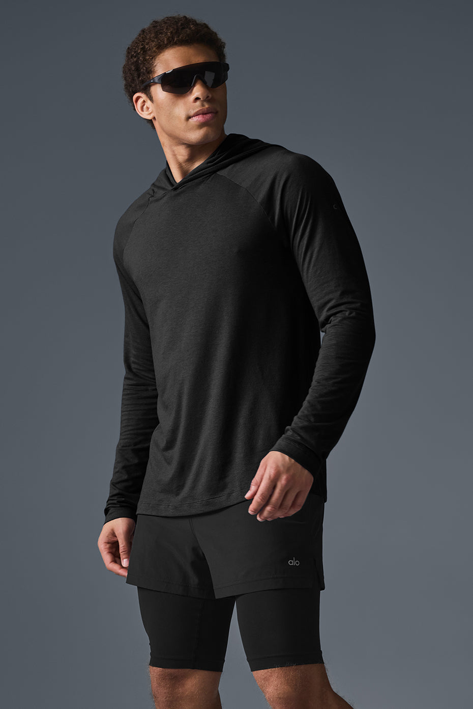 Close-up of the Core Hooded Runner black hoodie highlighting the raglan sleeve design