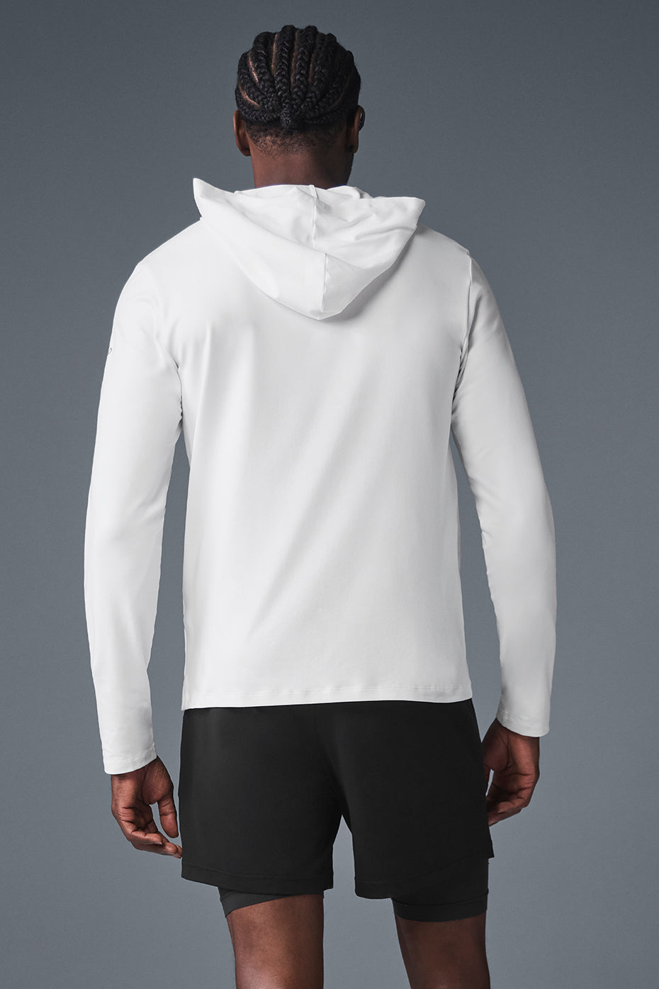 Back view showcasing the fitted design of the long sleeve workout shirt with hood.
