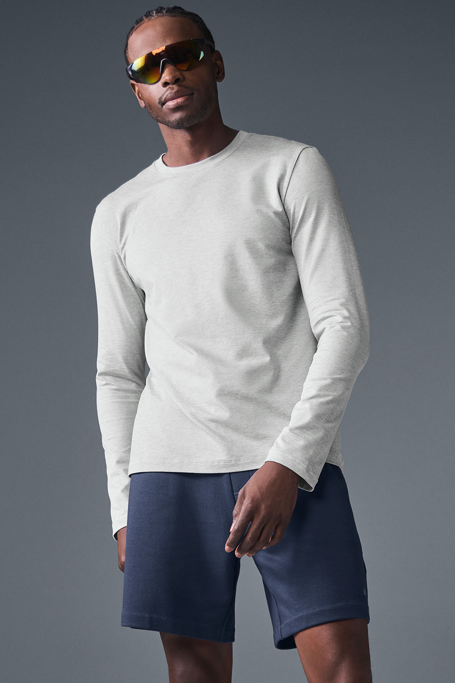 Model wearing athletic Heather Grey crewneck sweatshirt in street setting