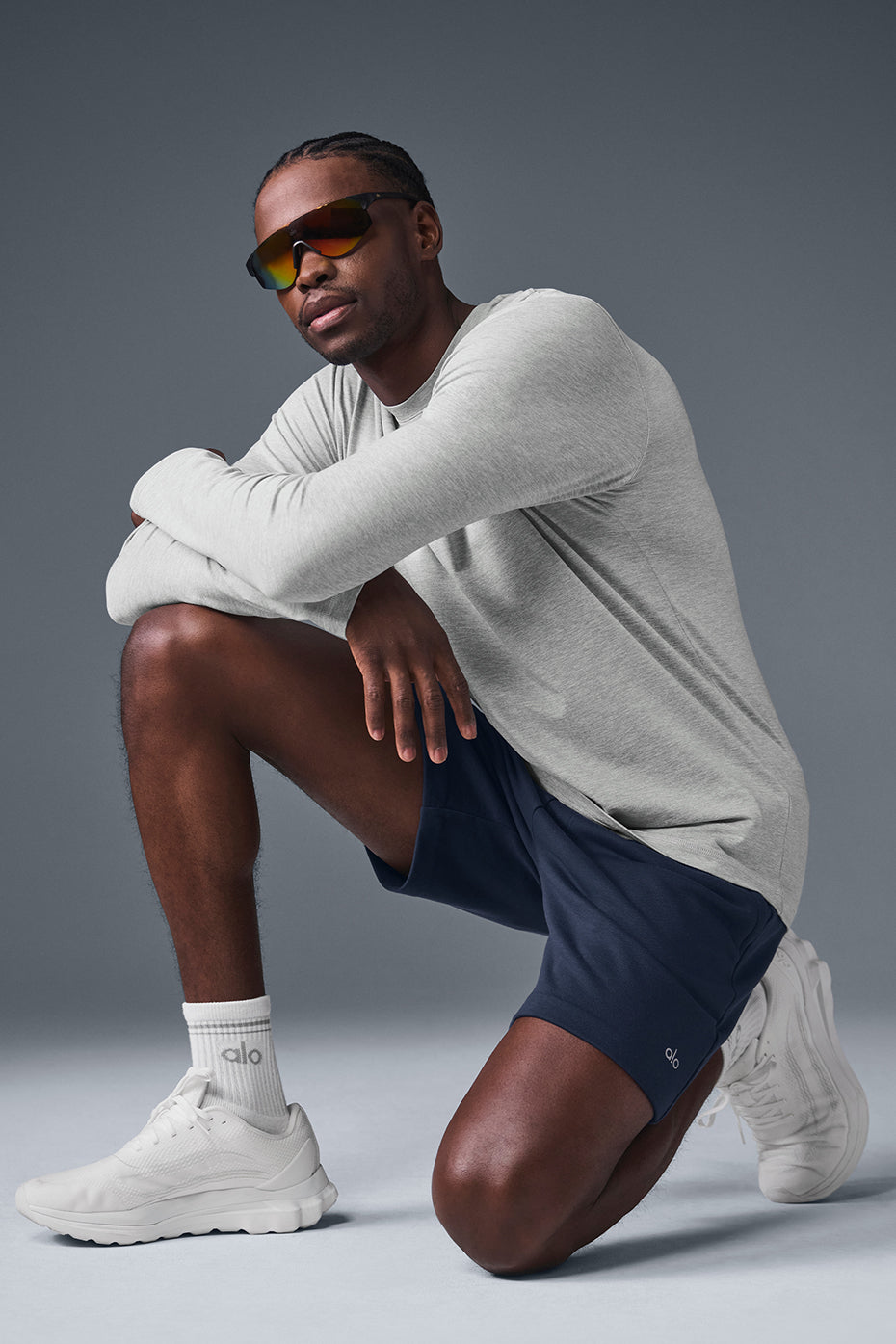 Model wearing athletic Heather Grey crewneck sweatshirt in street setting