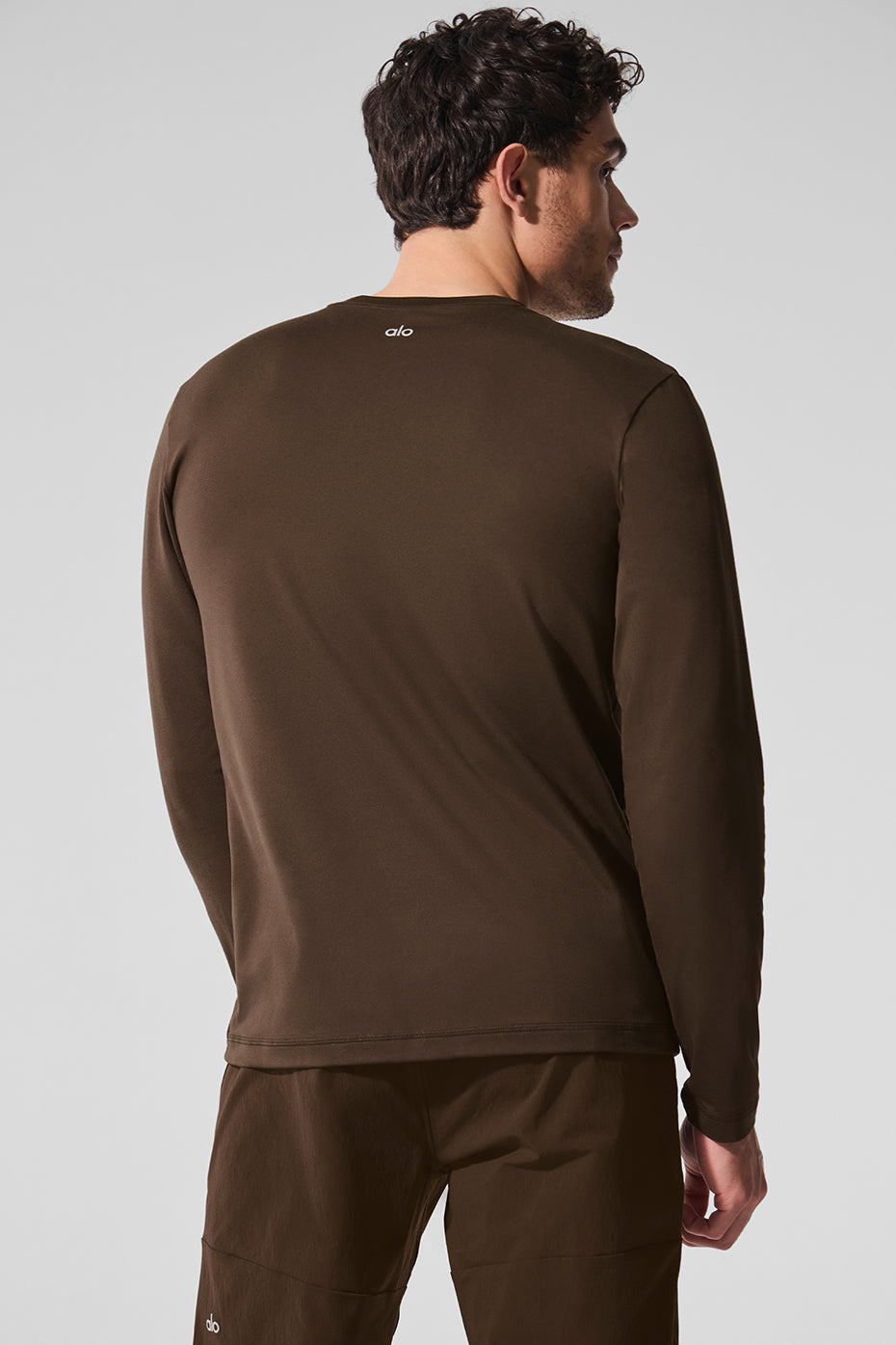 Model layering the crewneck sweatshirt under a jacket.