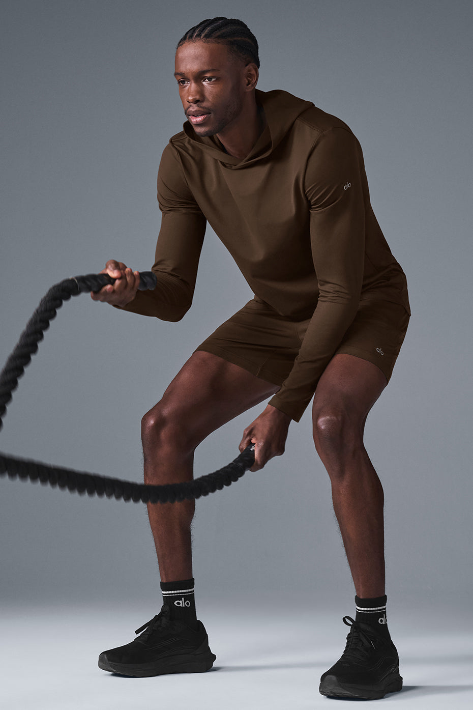 Model wearing the long sleeve hoodie during soccer training in a park setting