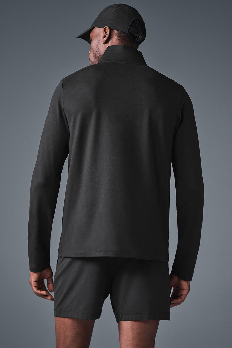 Model wearing Elevate 1/4 Zip Long Sleeve shirt during an outdoor workout.