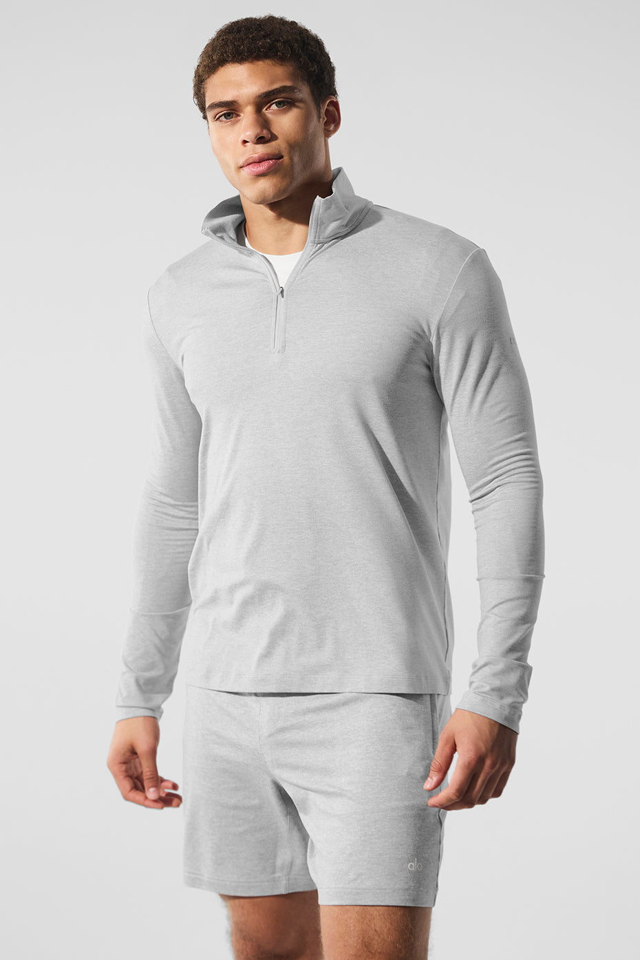 Athlete wearing moisture-wicking long sleeve crop top workout in grey.