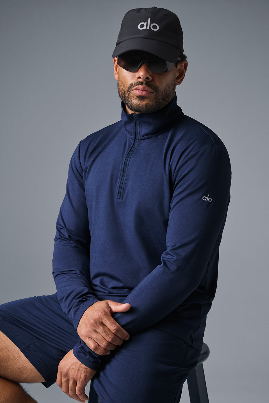 Front view of navy fitness long sleeve shirt with quarter zip collar.