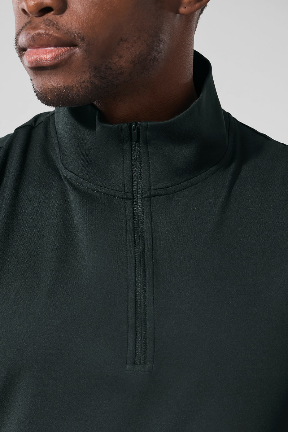 Front view of moisture-wicking long sleeve crop top in charcoal green.