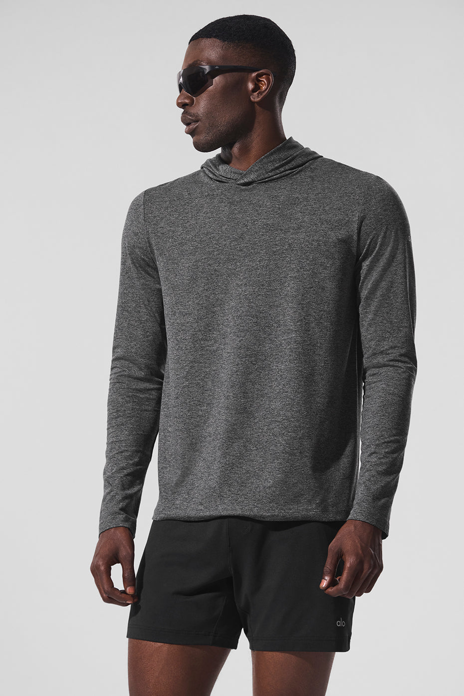Long sleeve shirt hoodie draped on a gym bench