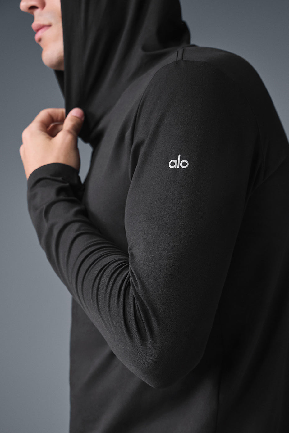 Front view of the black moisture-wicking long sleeve hoodie with hood, suitable for training or casual outfits