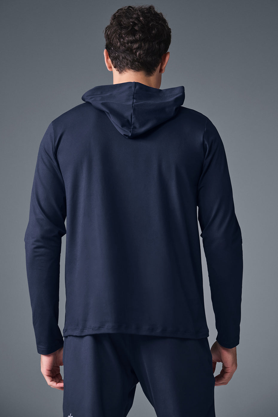 Back view highlighting the moisture-wicking features of the hoodie in action.