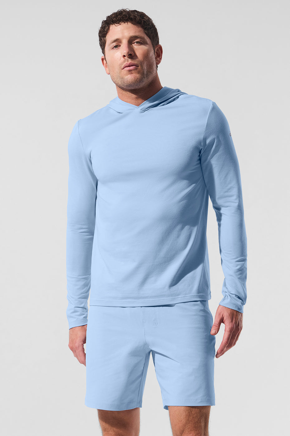 Close-up of moisture-wicking long sleeve hoodie fabric showing stretch and breathability
