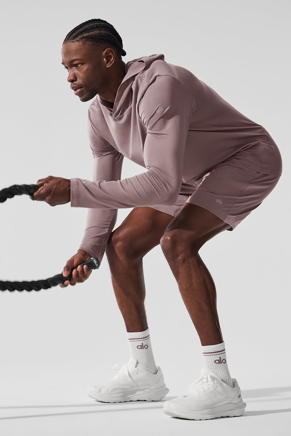 Side angle of Conquer Reform long sleeve shirt showing flexibility during exercise.