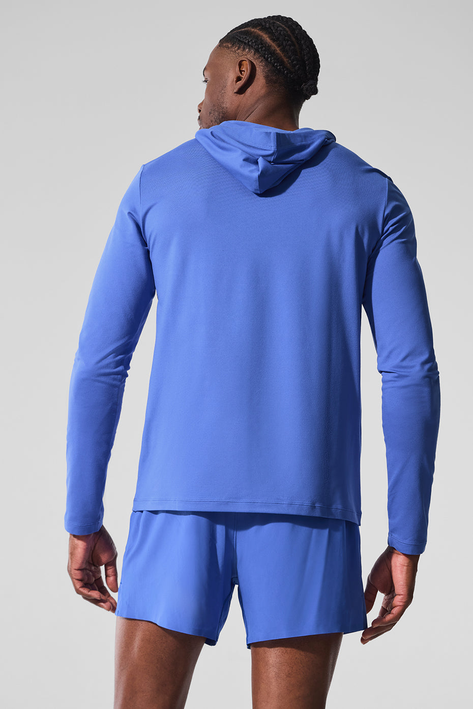 Casual streetwear style featuring this performance long sleeve hoodie layered over a tee