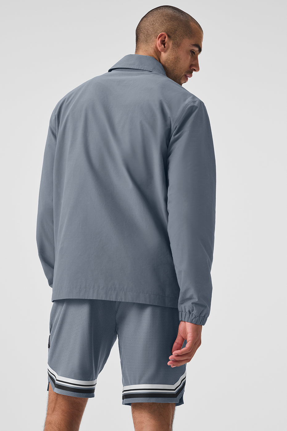 Side view of the mens wool overshirt, highlighting the zippered pockets and elastic cuffs.