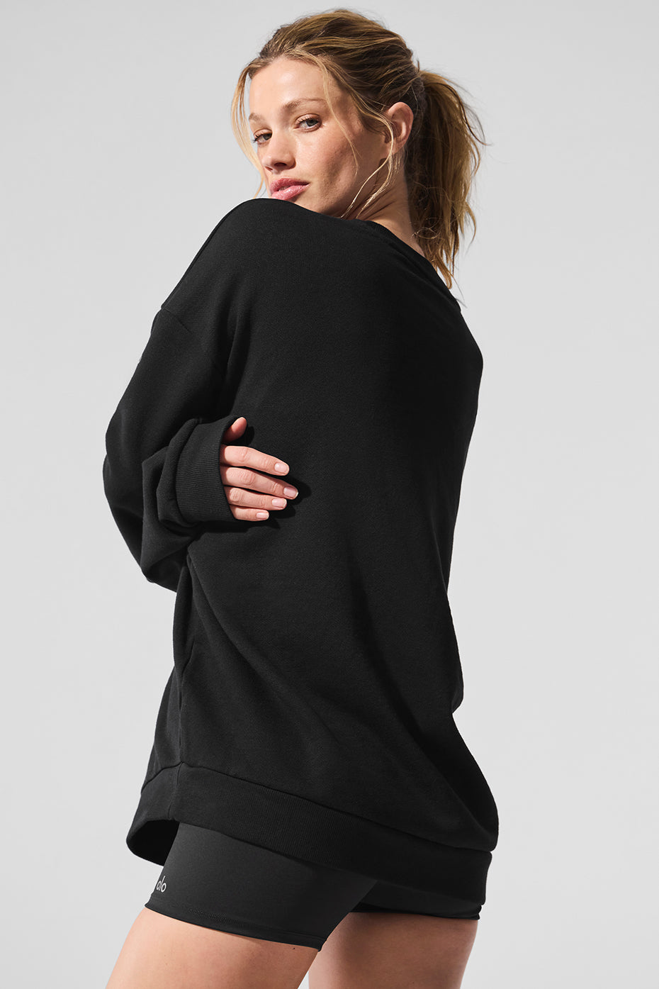 Athlete wearing black pullover during a cooldown stretch in a NYC studio