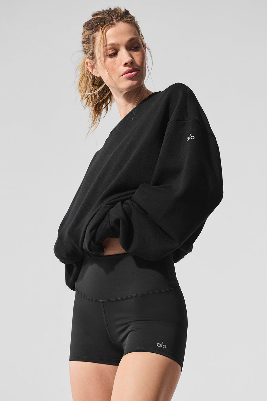 Layered outfit featuring the pullover with workout leggings and sneakers