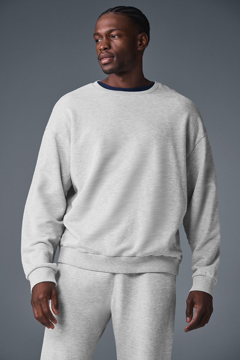 Close-up of heather grey crewneck sweatshirt cuffed sleeve detail with soft French terry texture