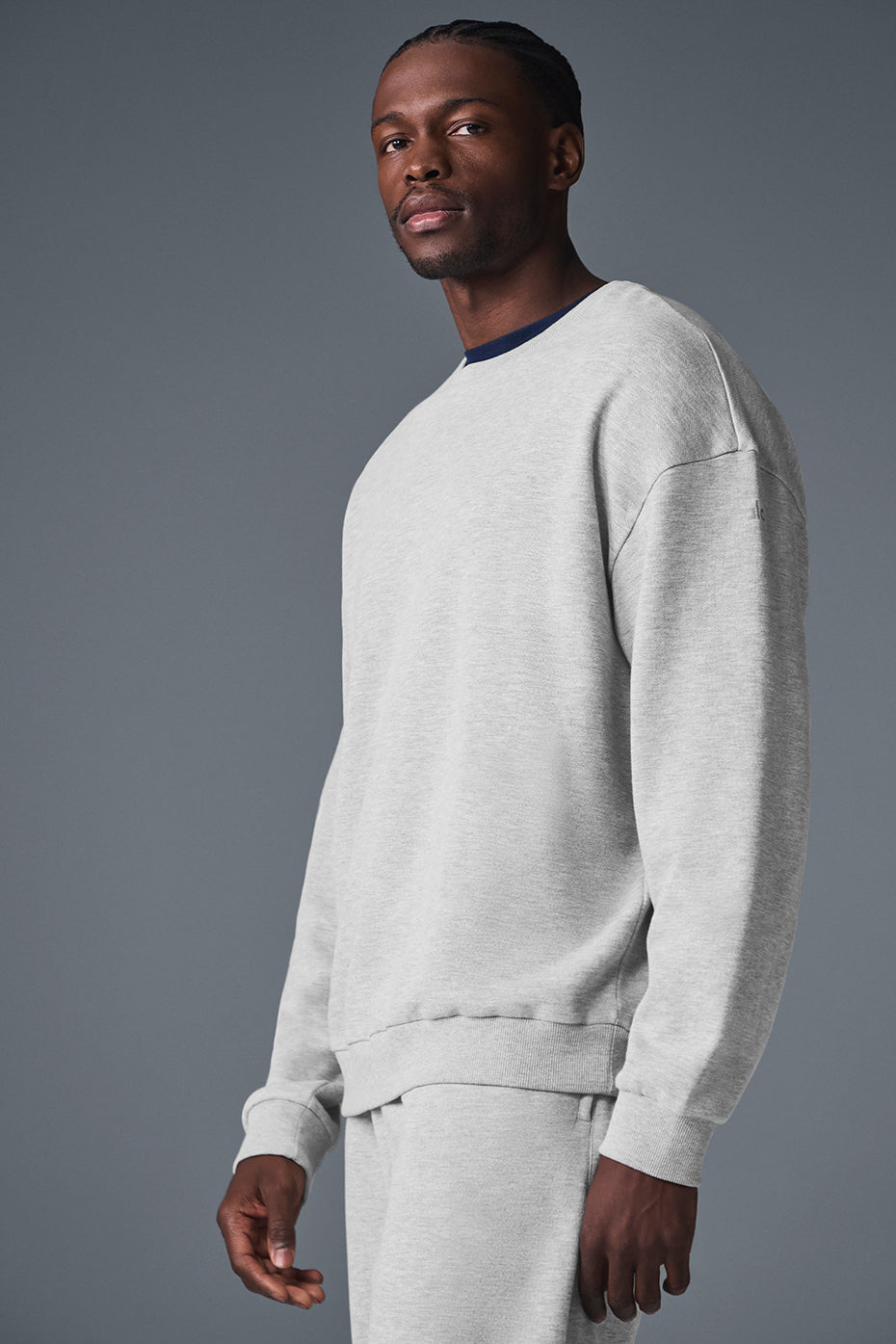 Flat-lay of sport tek 1 4 zip pullover and crewneck sweatshirt combo on locker room bench