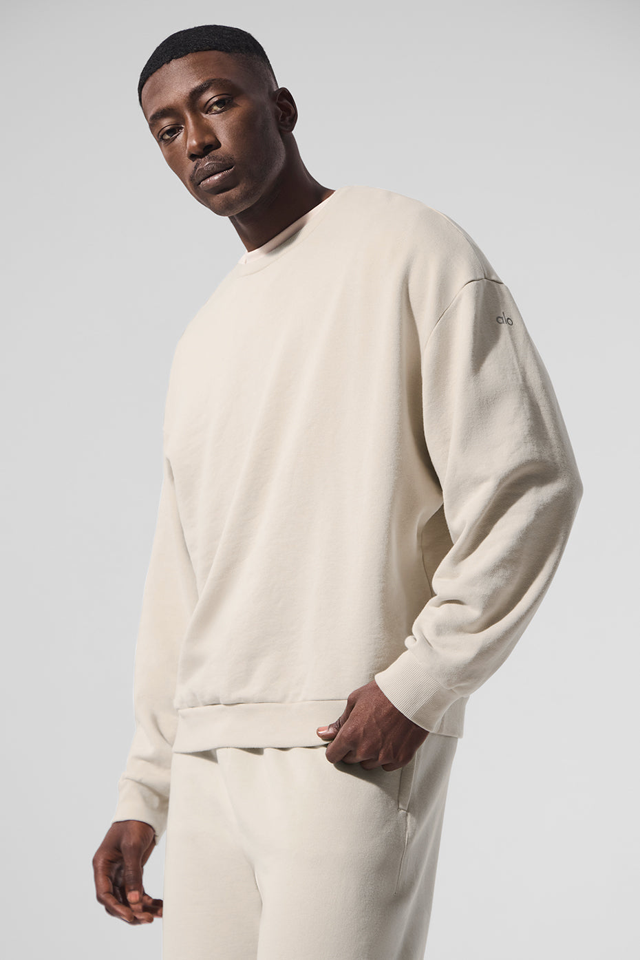 Close-up of French terry pullover hoodie in bone color with cuffed sleeves