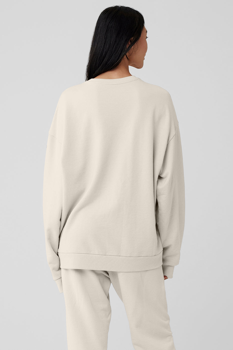 Side view of the Chill Crew Neck Pullover, highlighting the cuffed sleeves.