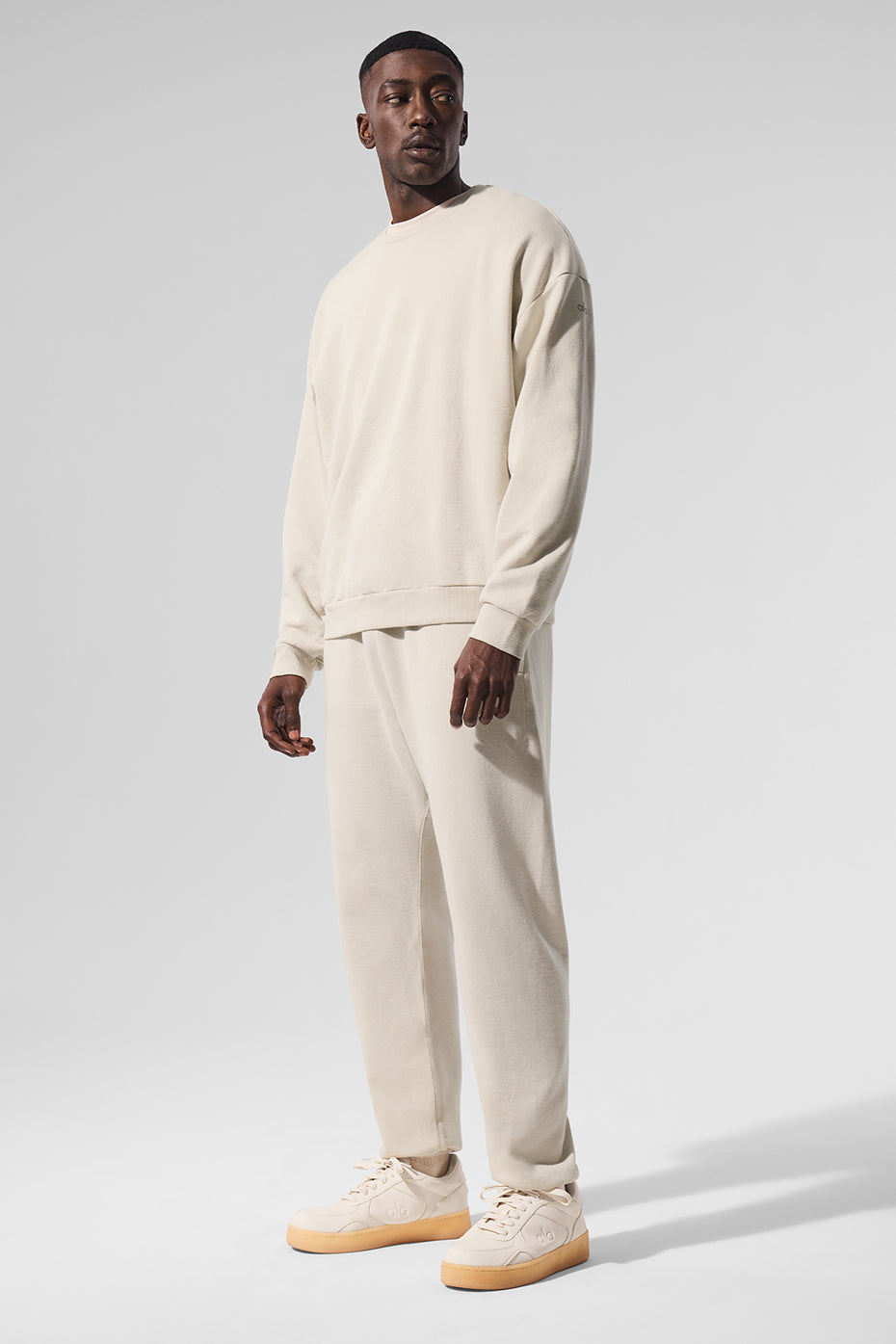 Close-up of French terry pullover hoodie in bone color with cuffed sleeves